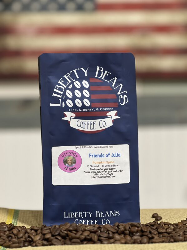 Liberty Beans coffee bag with coffee beans scattered