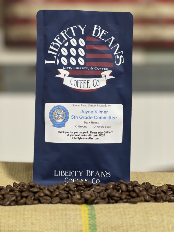 Liberty Beans coffee bag with scattered beans.