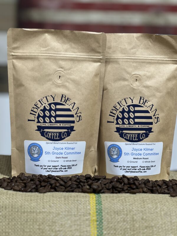 Liberty Beans coffee bags on burlap with beans.