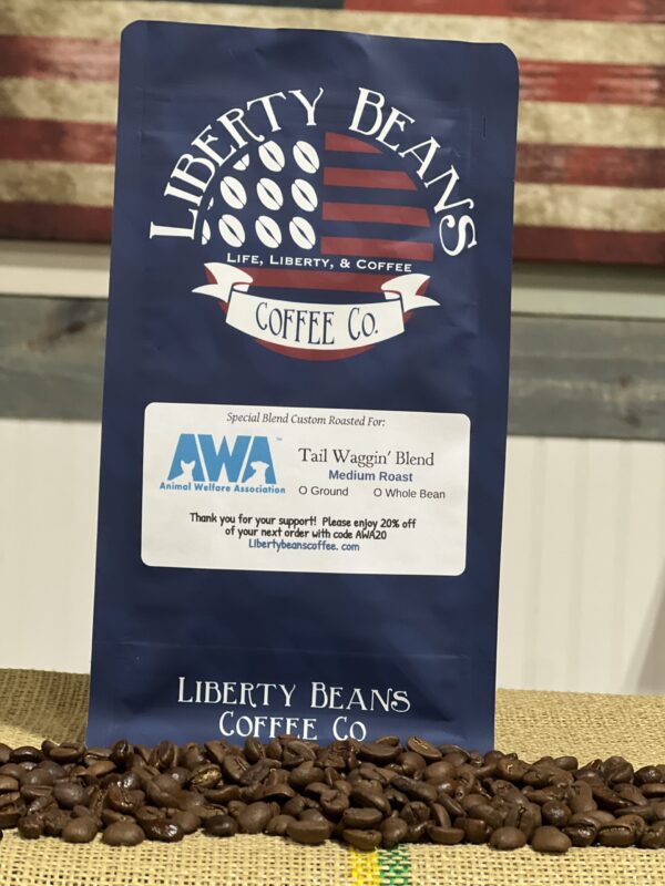 Liberty Beans coffee bag with roasted coffee beans.