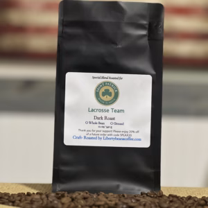 Dark roast coffee bag with American flag background.