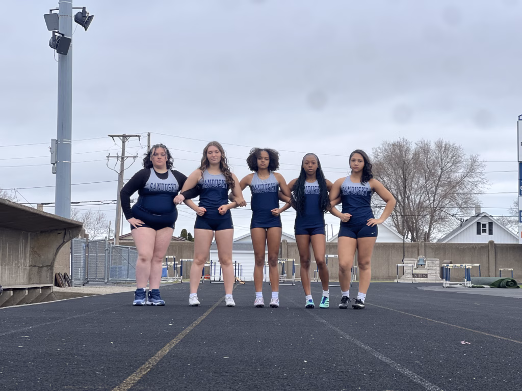 Track team posing on outdoor running track